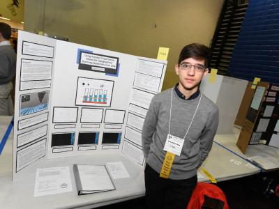 Aidan Hijazi-Klop standing with his project  